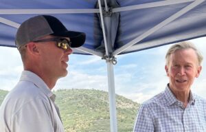 Citizens' Alliance President Jeff Peterson, left, explains impacts to the community to U.S. Sen. John Hickenlooper.